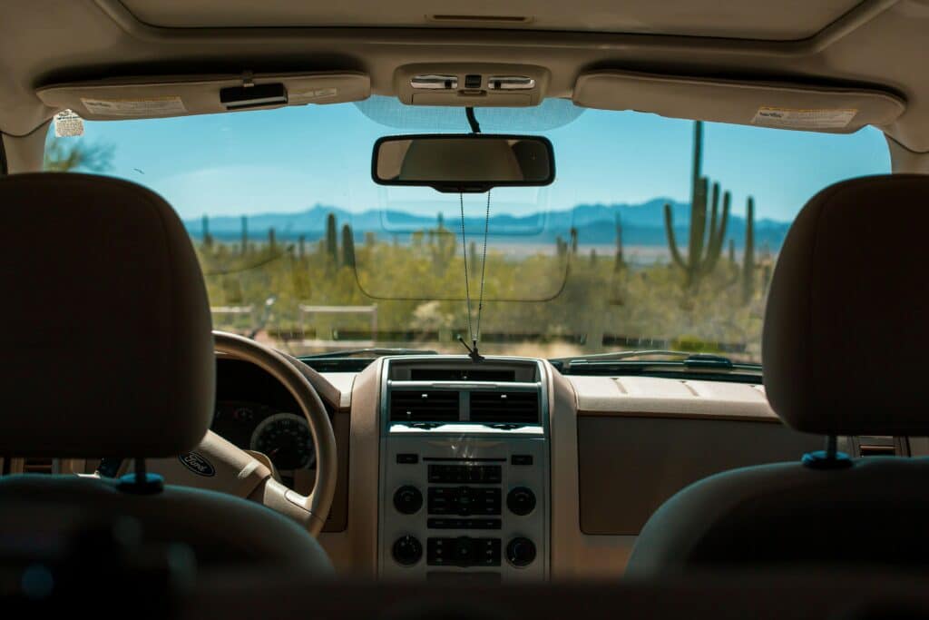 Interior view of a car driving through the Arizona desert, highlighting the setting for motor vehicle accidents and personal injury claims under Arizona’s comparative negligence laws.