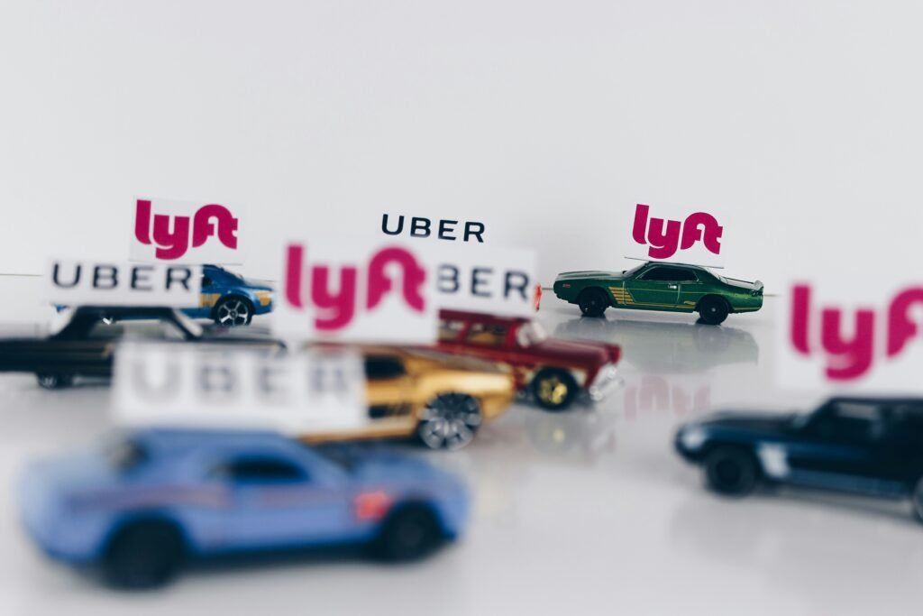 Toy cars labeled with Uber and Lyft logos symbolizing the growing presence of rideshare vehicles involved in personal injury claims.