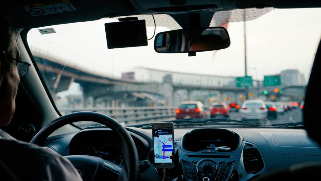 Interior of a rideshare car in traffic, showing navigation app and driver—relevant to Arizona rideshare accidents and liability in 2025.
