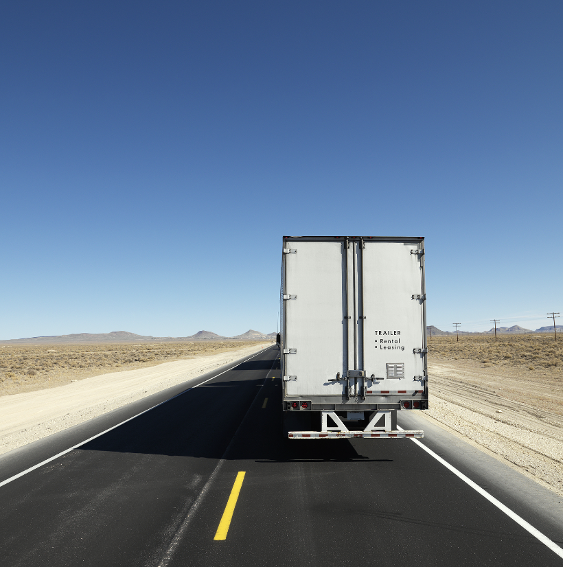Semi-truck driving on a desert highway near Las Vegas, symbolizing the dangers of trucking accidents and the need for a skilled Las Vegas truck accident lawyer.