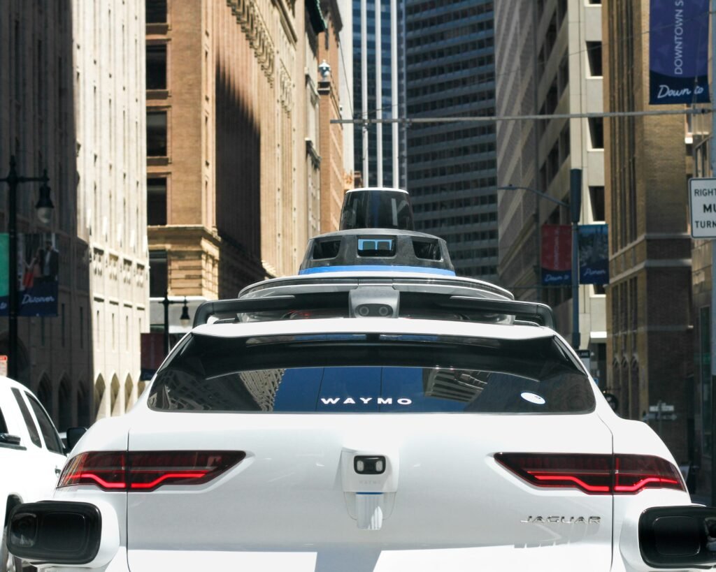 Nevada Self-Driving Car Laws: Your Essential Guide for 2025 White self-driving car with roof-mounted sensors picking up a passenger on a busy city street.