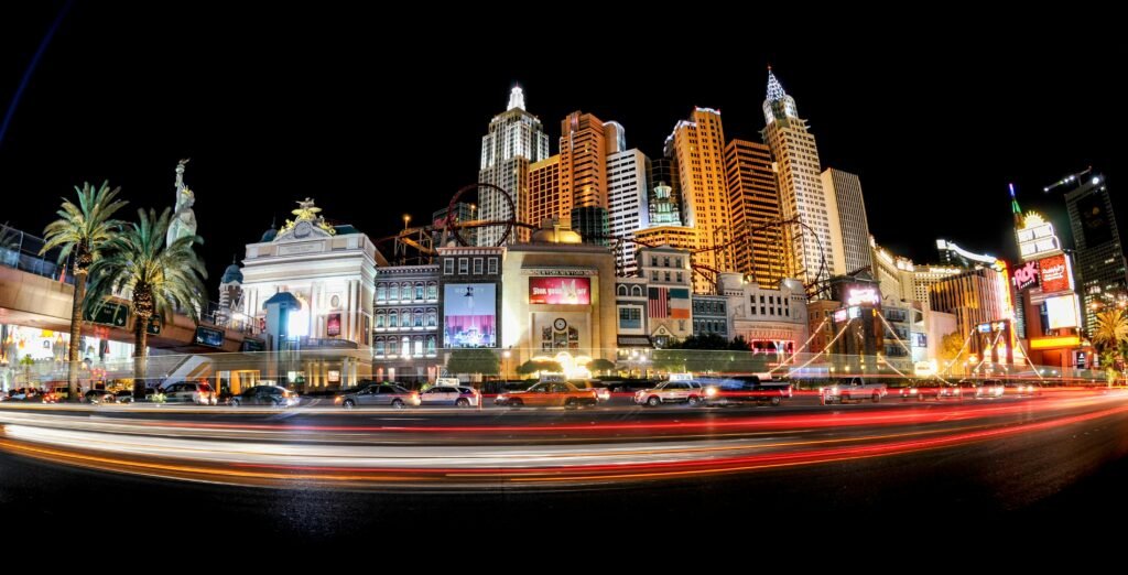 Las Vegas traffic at dusk with cars and pedestrians crossing an intersection, representing Nevada road safety concerns during the 100 Deadliest Days of Summer.