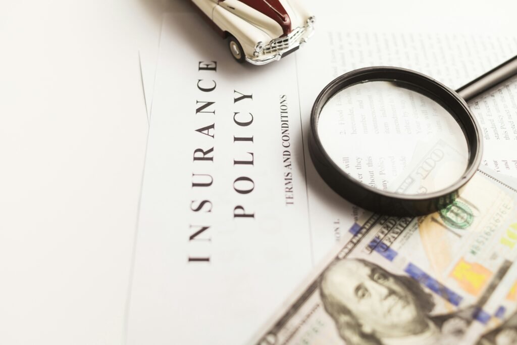 Insurance paperwork under a magnifying glass symbolizing the importance of uninsured motorist coverage details