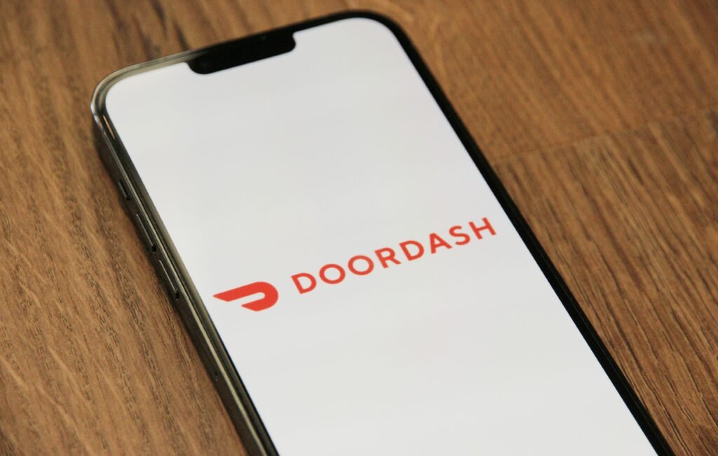 Close-up of the DoorDash delivery app, representing popular side hustles using a car.