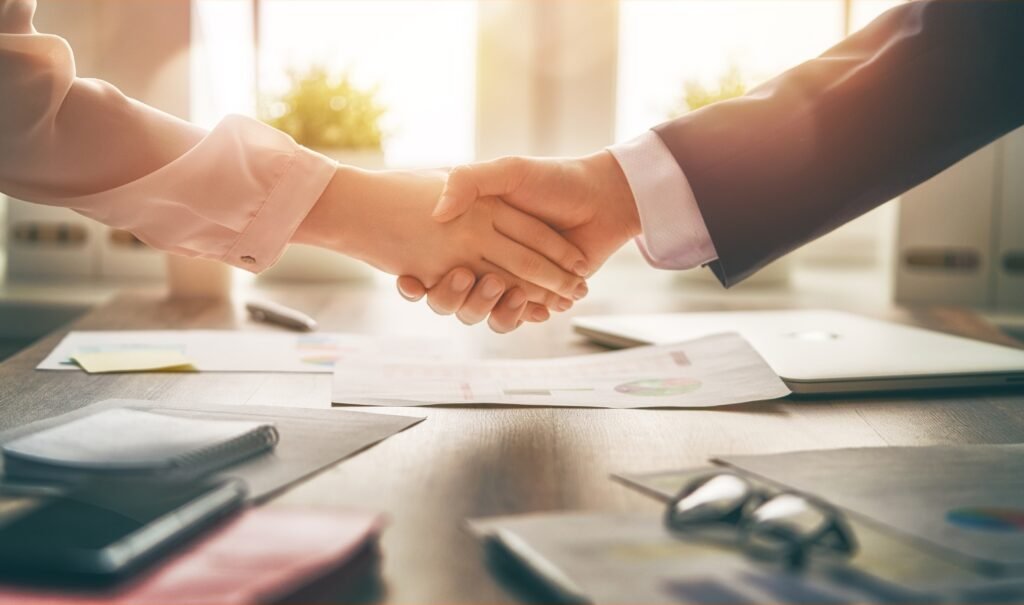 Two people shaking hands during a consultation, representing choosing a personal injury attorney you can trust.