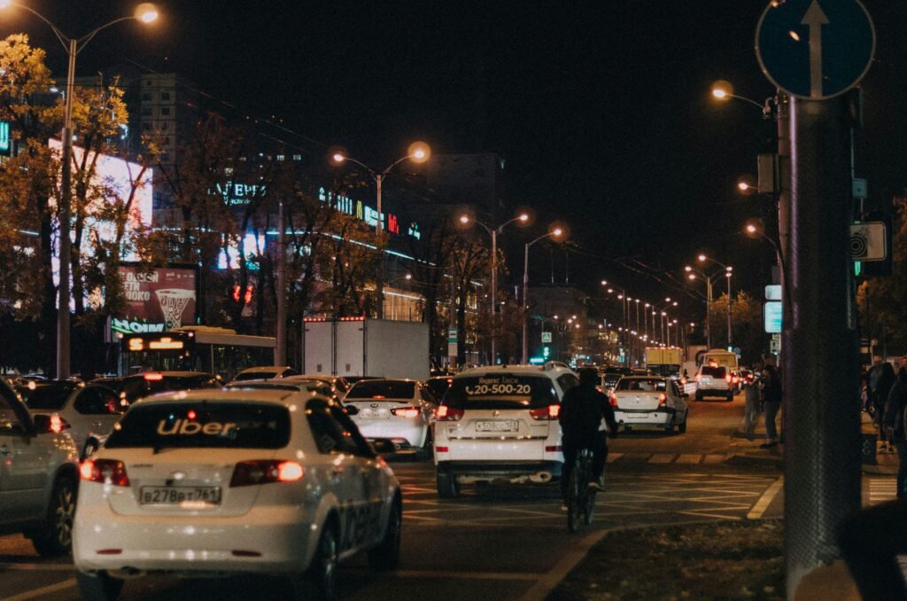 Uber rideshare vehicle driving through a city street, representing transparency and cost questions in rideshare pricing