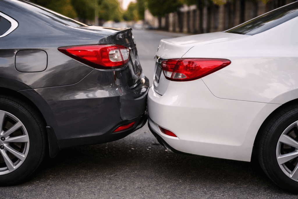 Minor car crash with two vehicles lightly touching in a low-speed rear-end collision with no visible damage