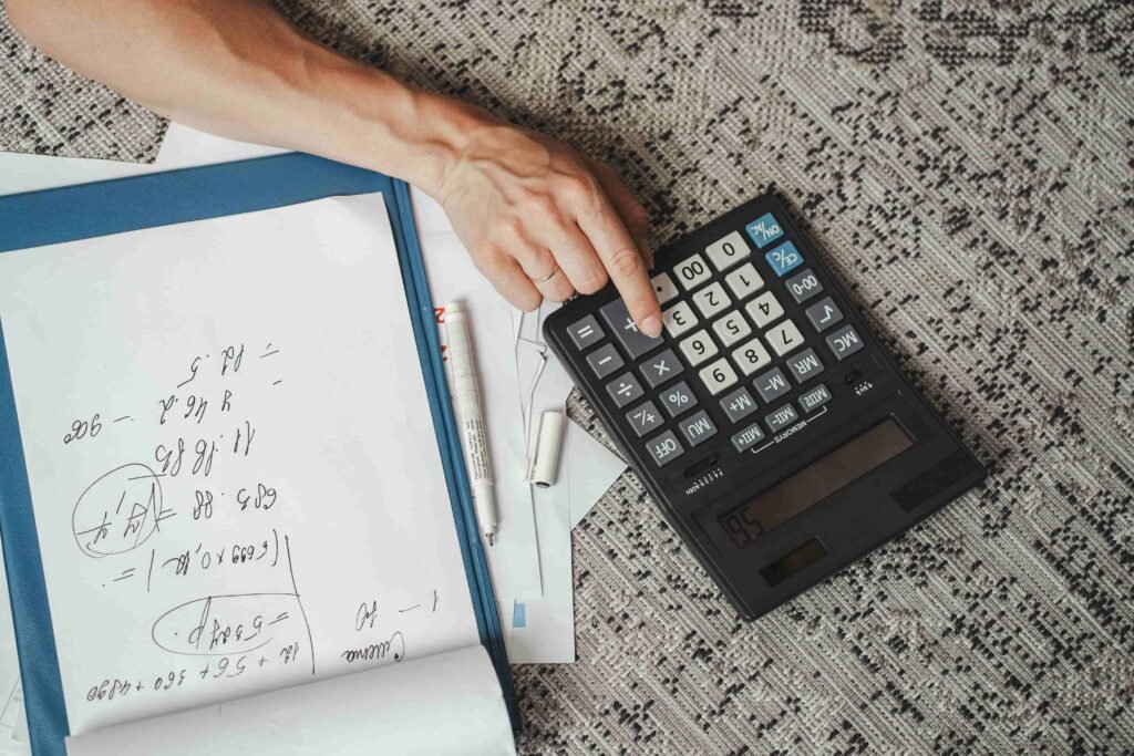 A person using a notepad and calculator to determine a pain and suffering settlement in a Nevada personal injury case.