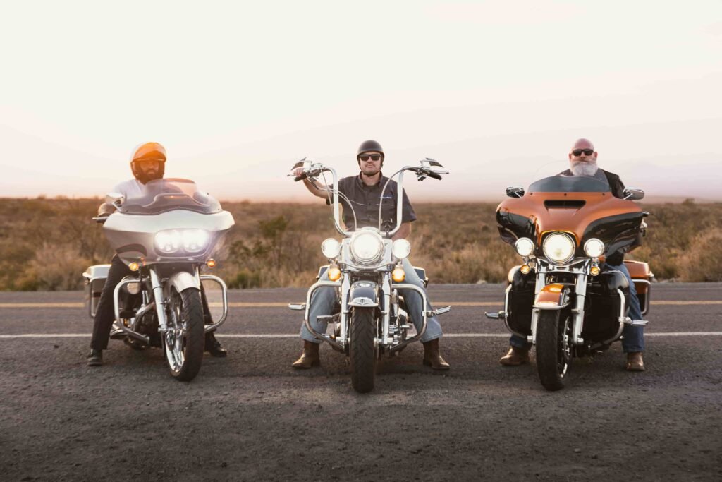 Three motorcyclists parked side by side on a Nevada roadway, highlighting motorcycle safety awareness and visibility for riders.
